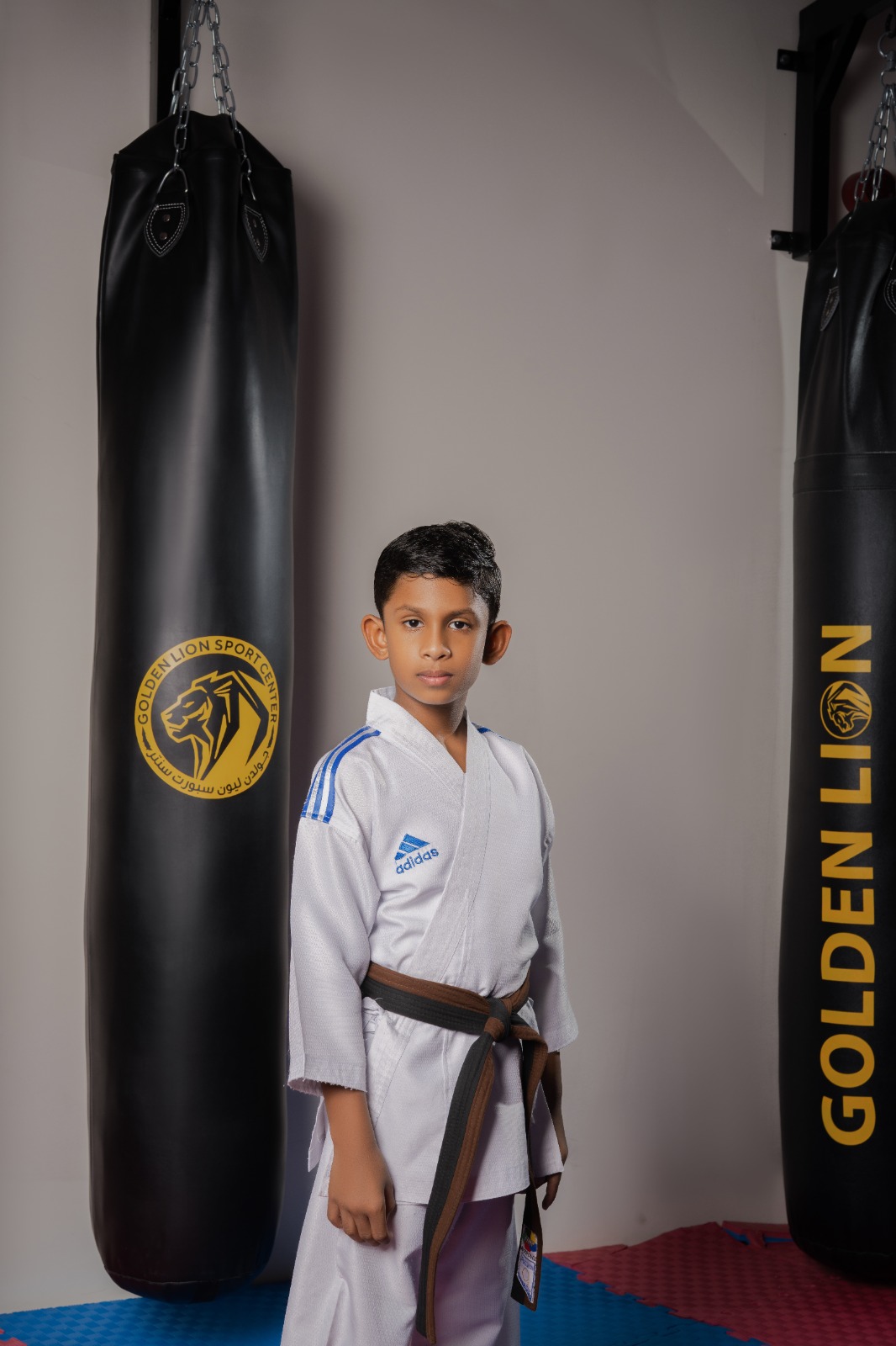 Junior student in front of a Golden Lion heavy bag