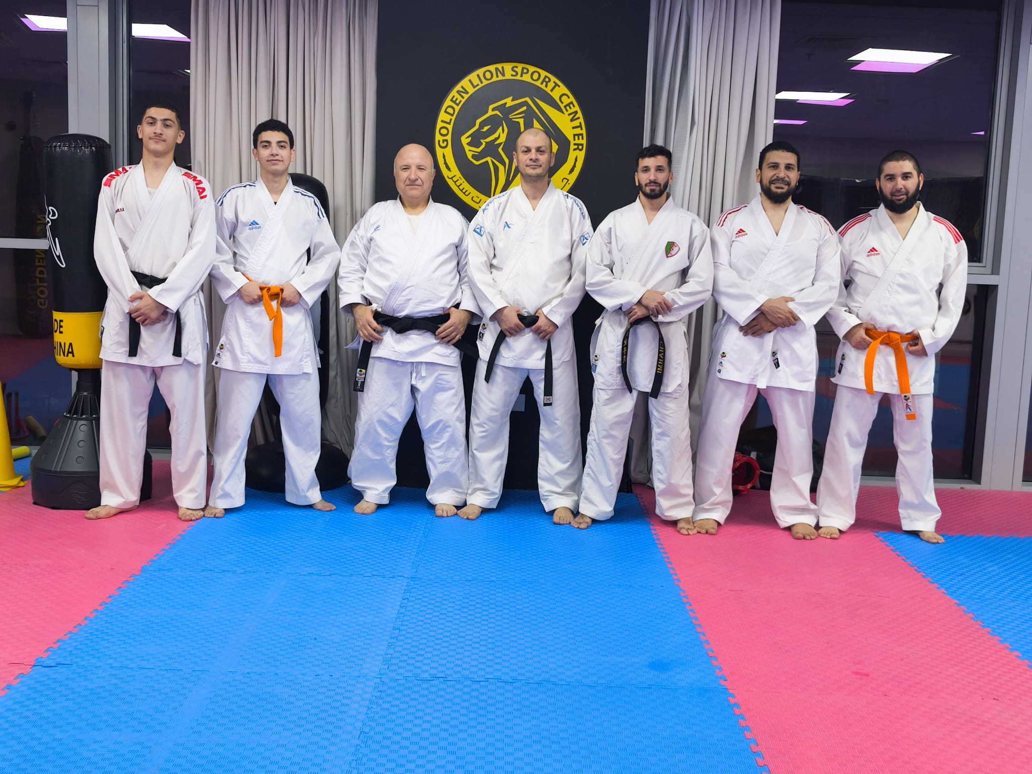 Golden Lion instructor team in front of the club banner